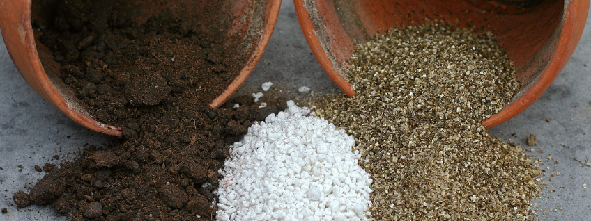 Clay pots with peat, perlite, and vermiculite pouring out